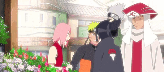 a group of anime characters are standing next to each other in front of a building and flowers .