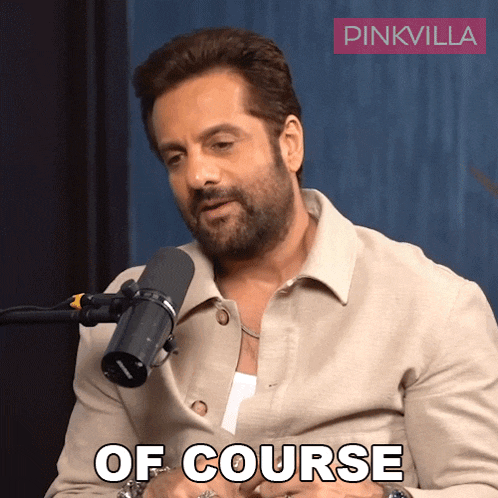 a man sitting in front of a microphone with the words of course written below him