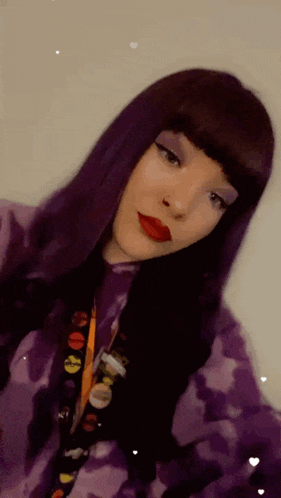a woman with purple hair and red lipstick