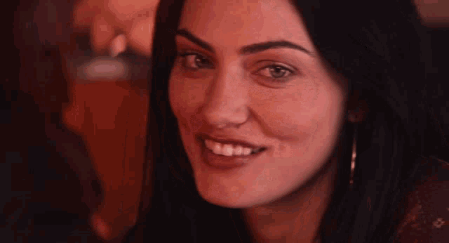 a close up of a woman 's face with a smile