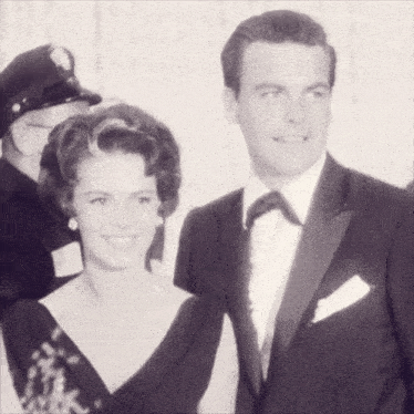 a black and white photo of a man and a woman smiling