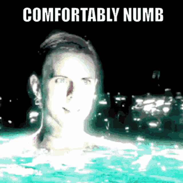 a man is swimming in a pool with the words comfortably numb written above him