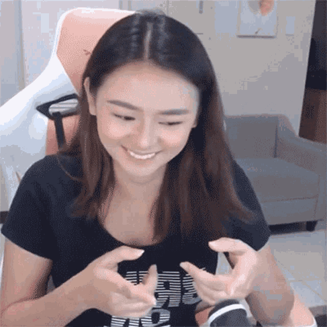 a woman wearing a black t-shirt that says ' i love you ' on it