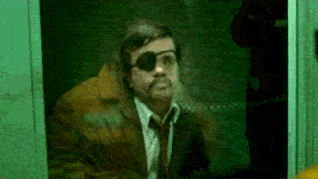 a man in a suit and tie with an eye patch on his eye