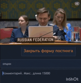 a man is sitting at a desk with a sign that says russian federation