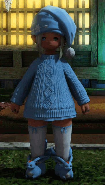 a girl wearing a blue sweater and a blue hat