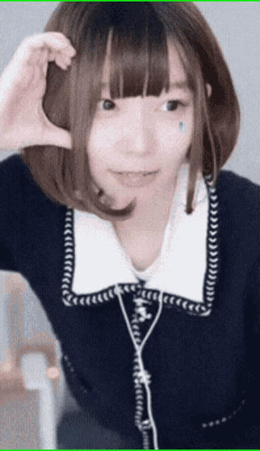 a girl with short hair is wearing headphones and a blue shirt
