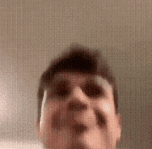 a close up of a man 's face with a blurred background