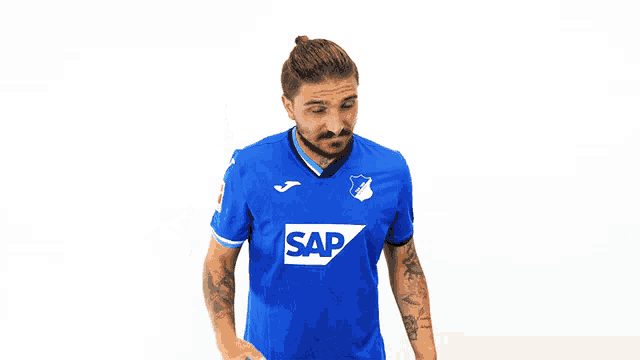 a man wearing a blue shirt with the word sap on the front