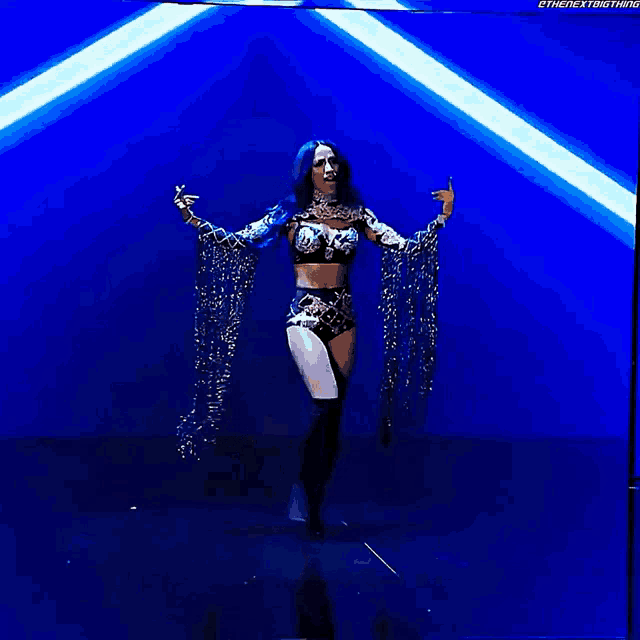 a woman is dancing on a stage with the next thing written on the bottom left