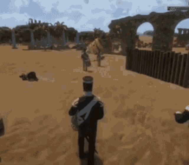 a man in a military uniform is walking through a desert