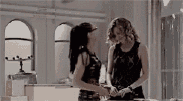 a couple of women are standing next to each other in a room .