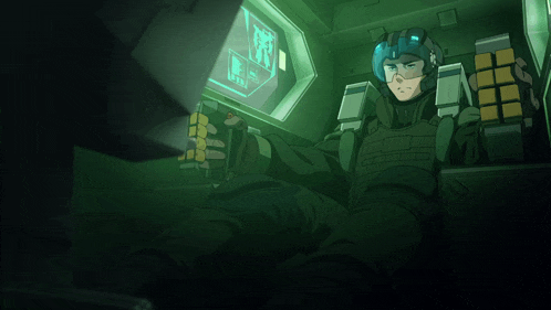 a man in a helmet is sitting in front of a computer screen that says ' r.i.t. ' on it