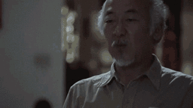 a man with a beard is blowing a kiss