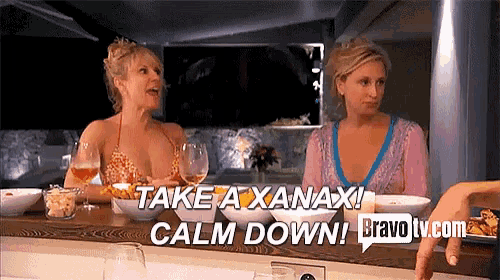 two women sitting at a table with the words take a xanax calm down bravo tv.com