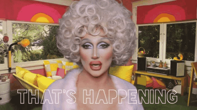 a drag queen says that 's happening in front of a couch