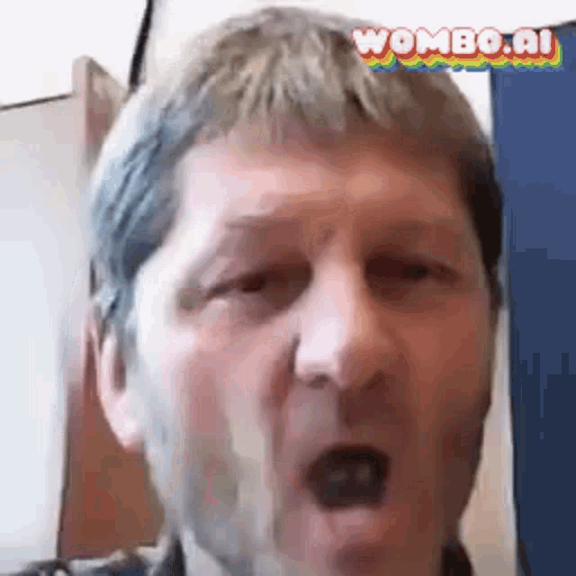 a man with a beard is making a funny face while looking at the camera .