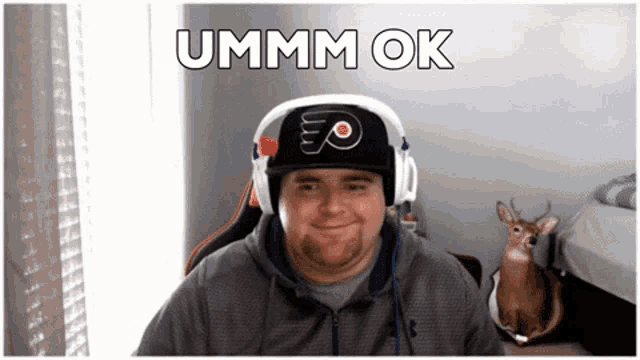 a man wearing headphones and a hat that says ' flyers ' on it