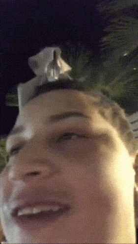 a close up of a person 's face at night