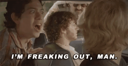 a group of people are sitting in a car with a police officer behind them and one of them is screaming .