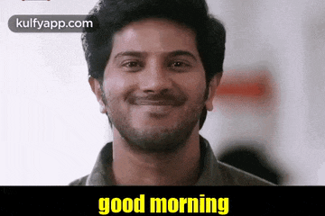 a man with a beard is smiling with the words `` good morning '' written below him .