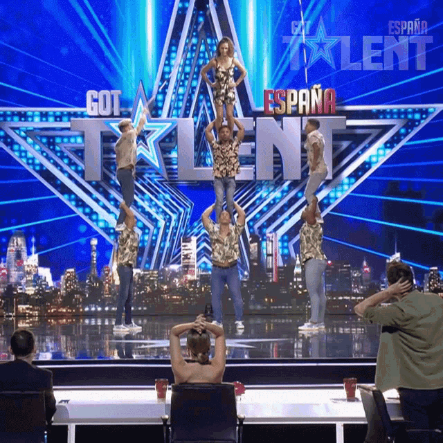 a group of people are performing on a stage in front of a sign that says got talent