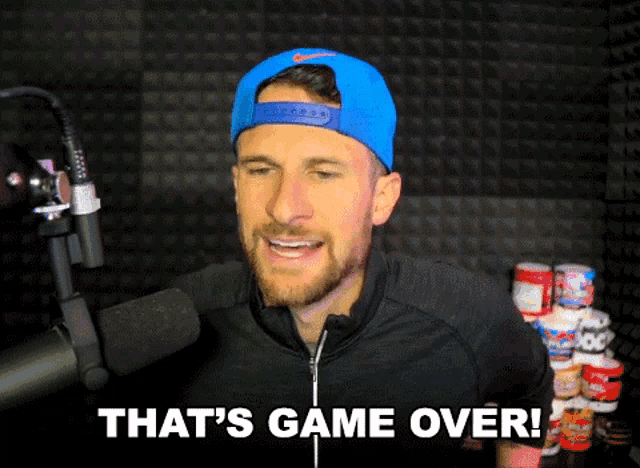 a man wearing a blue hat and a black jacket says that 's game over