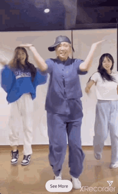 a woman in a blue shirt that says ' tigers ' on it is dancing