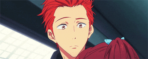 a man with red hair is looking at a girl