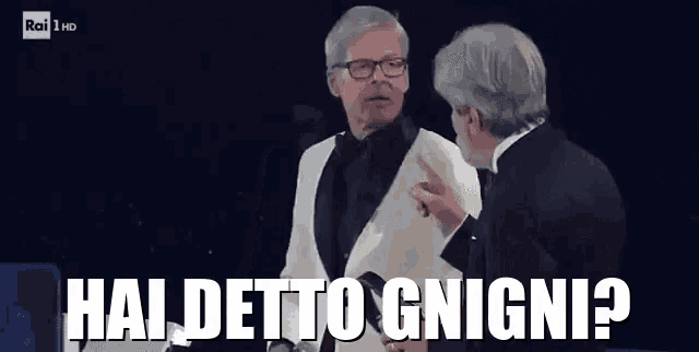 two men in tuxedos are talking to each other and one of them is pointing at the other and says haidetto gnigni ?