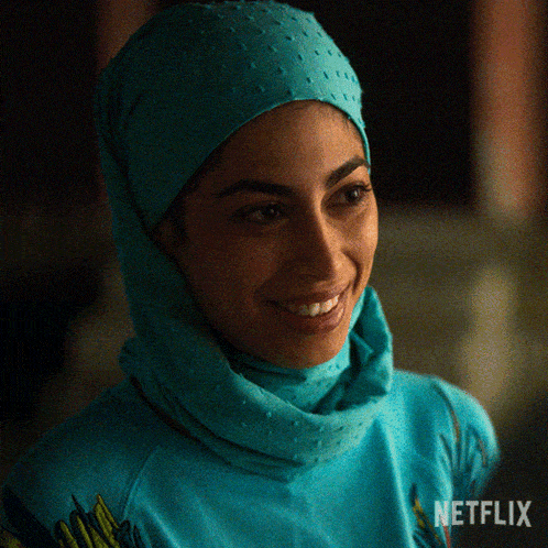 a woman wearing a turban and a blue shirt with the word netflix on the bottom