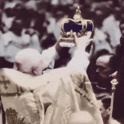 a man is holding a crown in front of a crowd of people