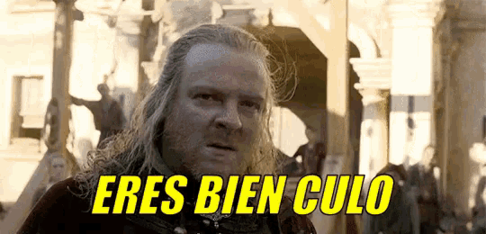 a man with long hair and a beard says eres bien culo in yellow letters