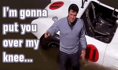 a man is standing in front of a white car with the words i 'm gonna put you over my knee