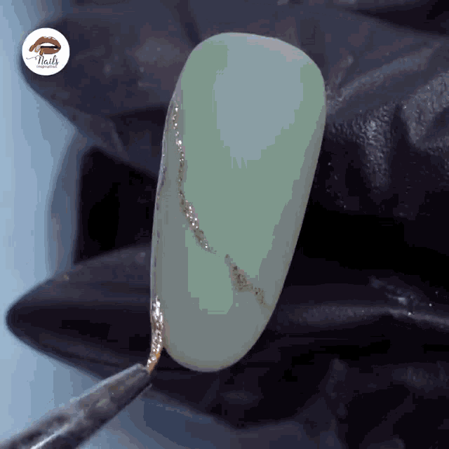 a close up of a green nail with the word nails on it