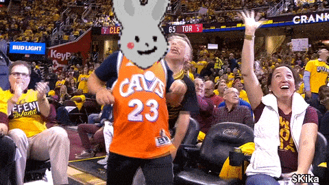 a man in an orange jersey with the number 23 on it is dancing