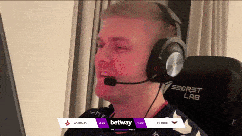 a man wearing headphones and a microphone is sitting in front of a computer screen that says astralis