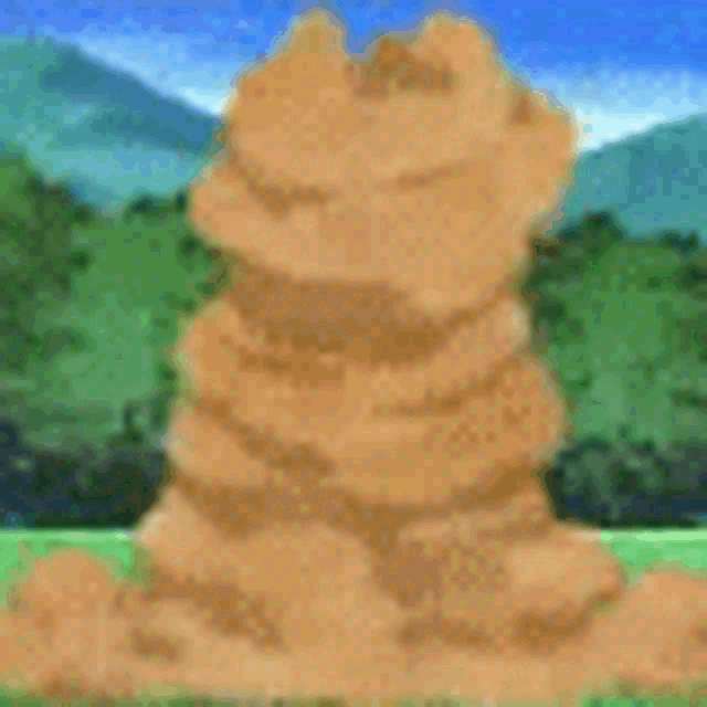 a pile of dirt is sitting in the middle of a field .