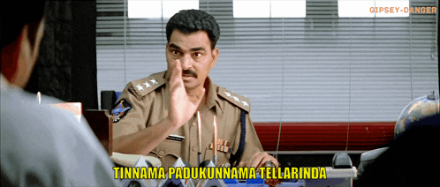 a man in a police uniform is talking to another man with a caption that says tinnama padukunnama tellarina