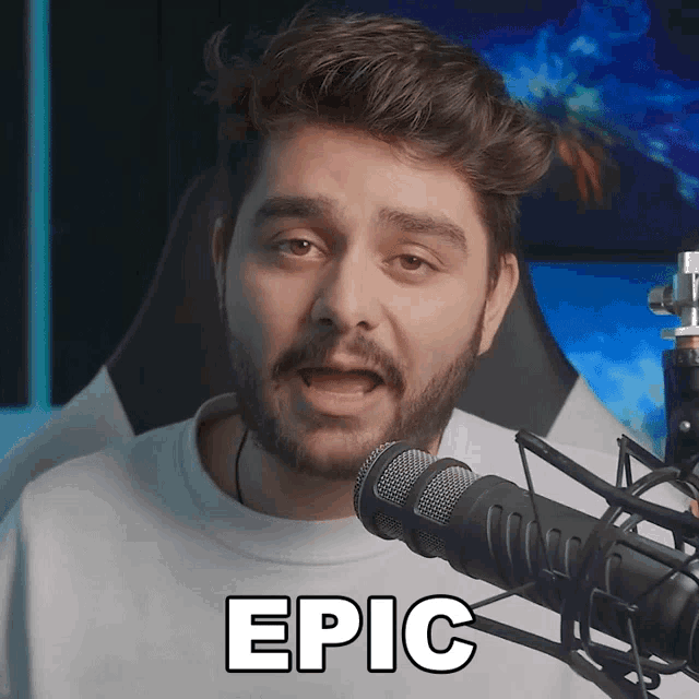 a man with a beard is speaking into a microphone and the words epic are above him