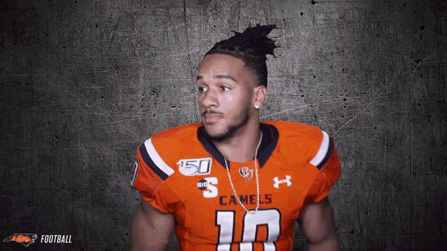 a football player wearing an orange jersey with the number 10