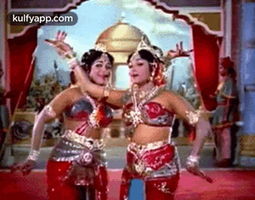 two women are dancing together in a movie .