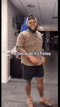 a man is dancing in a hallway while wearing flip flops .