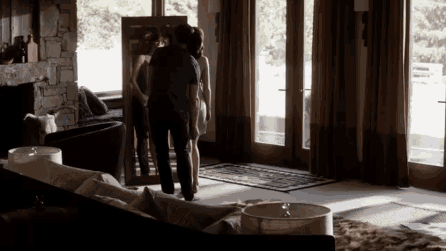 a man and a woman standing in a living room