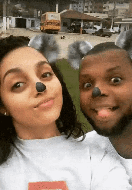 a man and a woman are posing for a picture with koala ears on their faces
