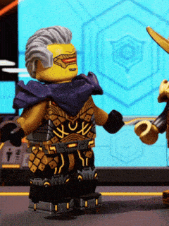 a lego figure with a purple scarf around his neck stands next to another lego figure