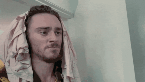 a man with a towel draped over his head