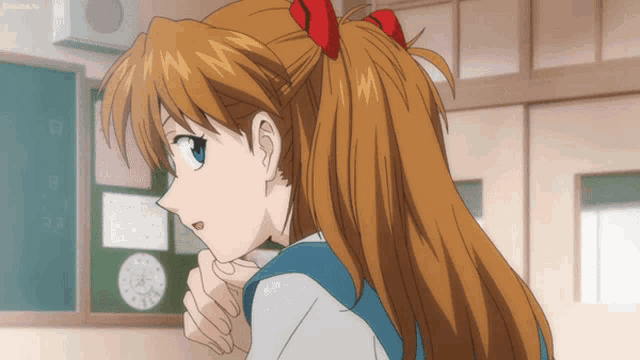 a girl with a red bow in her hair is looking over her shoulder in front of a blackboard
