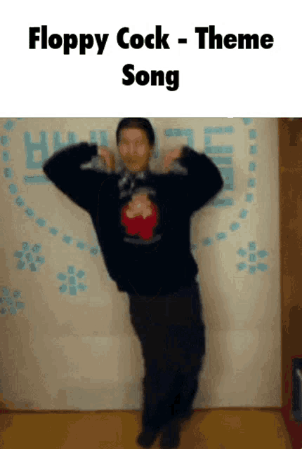a man is dancing in front of a wall with floppy cock theme song written on it