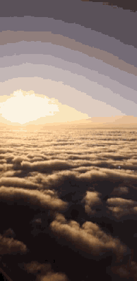 a cloudy sky with the sun shining through